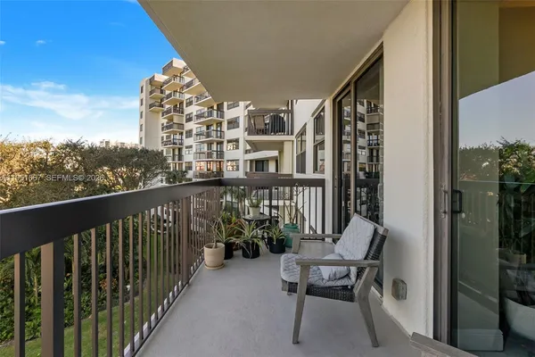 a view of a balcony with chair and front door
