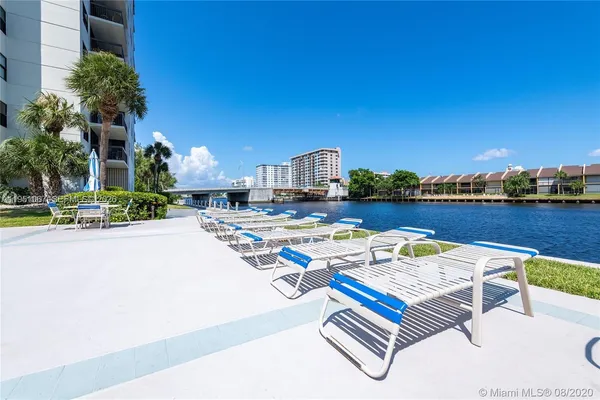 a view of swimming pool with outdoor seating and yard