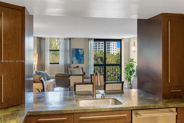 a kitchen with stainless steel appliances granite countertop a refrigerator and a counter top space