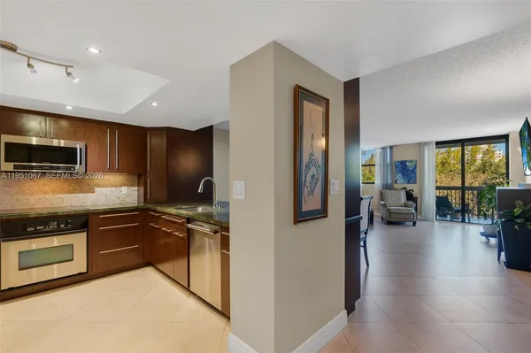 a kitchen with stainless steel appliances granite countertop a stove and a refrigerator