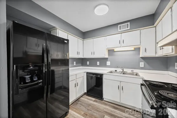 a kitchen with stainless steel appliances granite countertop a stove a refrigerator and a sink