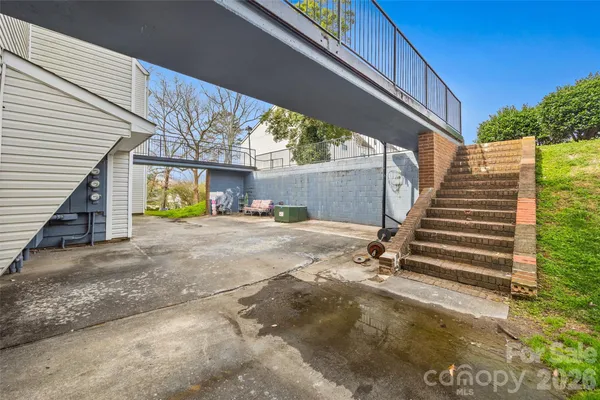 a view of a house with backyard space and wooden deck
