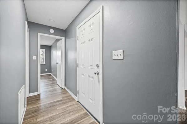 a view of a hallway with wooden floor