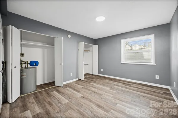 a view of empty room with wooden floor