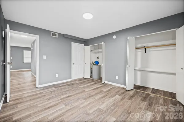 a view of a big room with wooden floor and closet