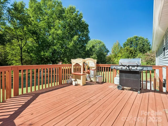 a balcony with wooden floor and fence