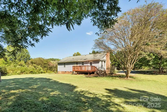 a yellow house with trees in front of it