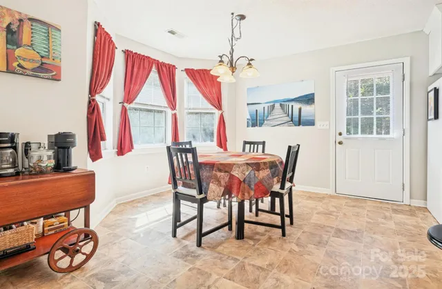 a dining room with furniture and a window