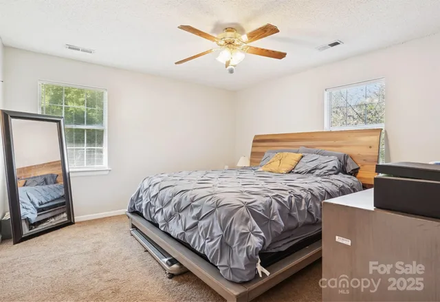 a bedroom with a bed and a tv