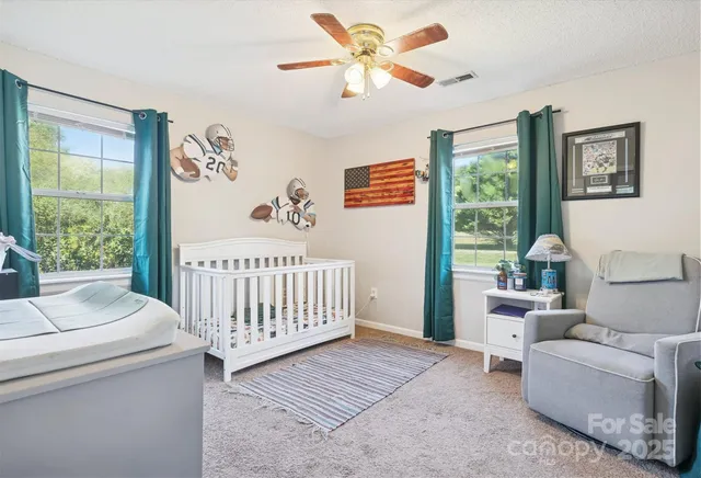 a bedroom with furniture and a large window
