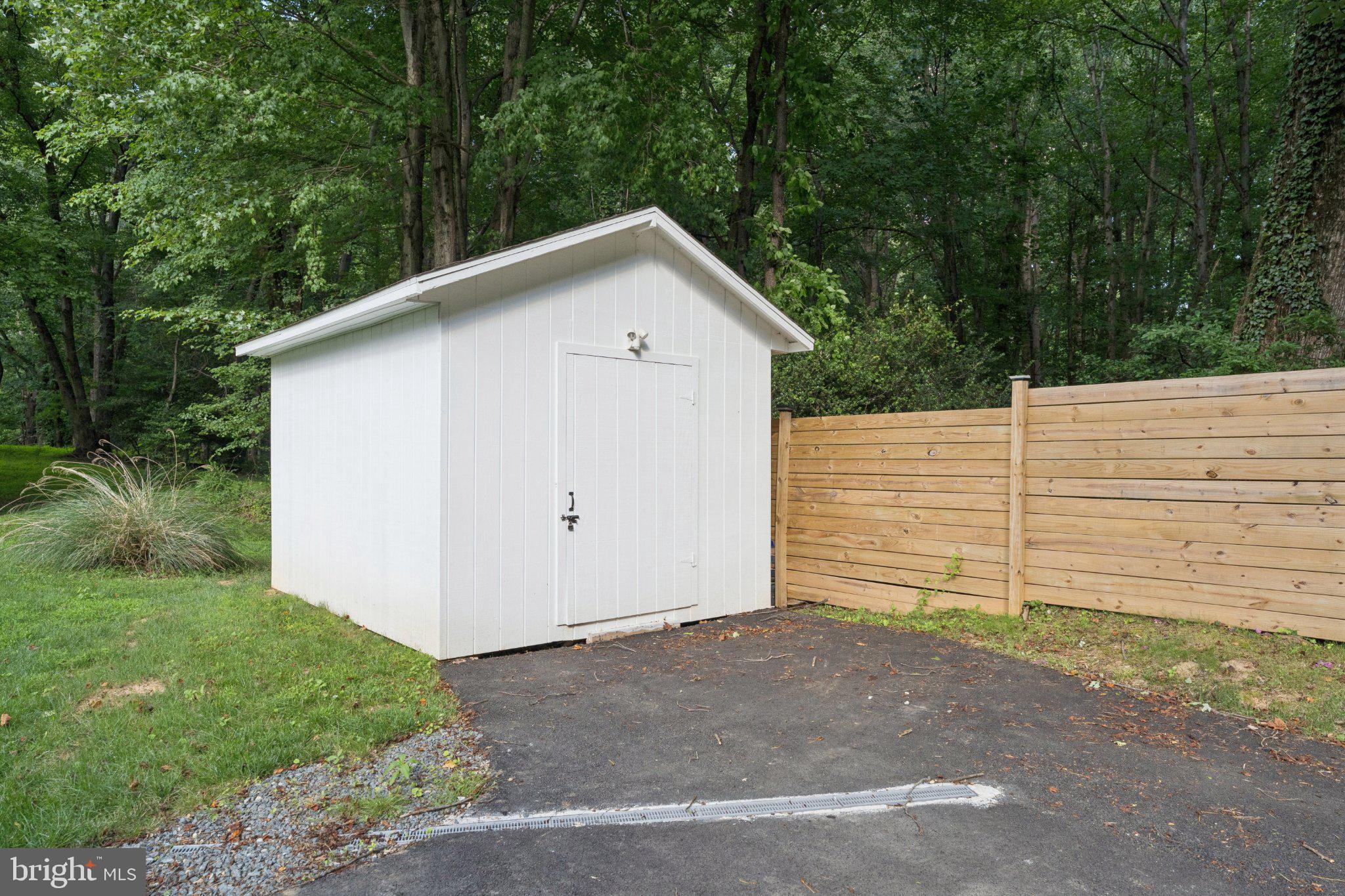 3219 Fox Mill Road Oakton, VA 22124 - Photo 74 of 87 Charming shed nestled in nature's embrace.
