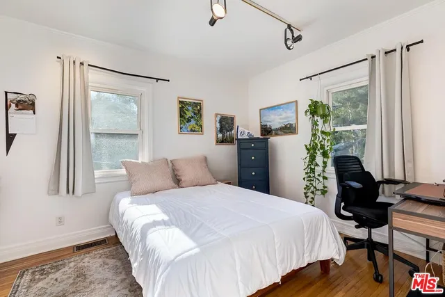 a bedroom with a balcony a bed and a couch