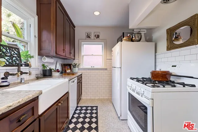 a kitchen with a sink stove and cabinets