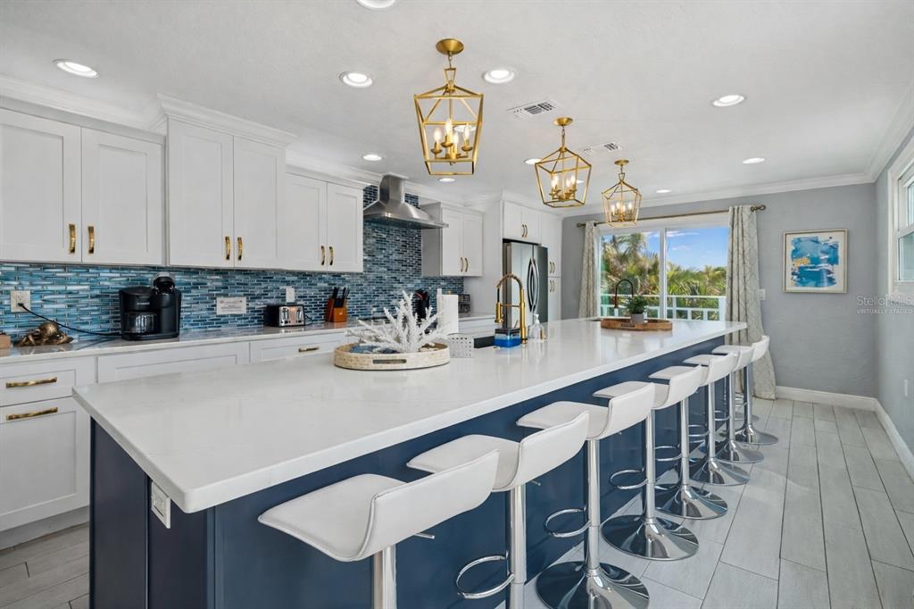 330 6th Avenue Indian Rocks Beach, FL 33785 - Photo 7 of 52 a kitchen with a dining table chairs sink and cabinets