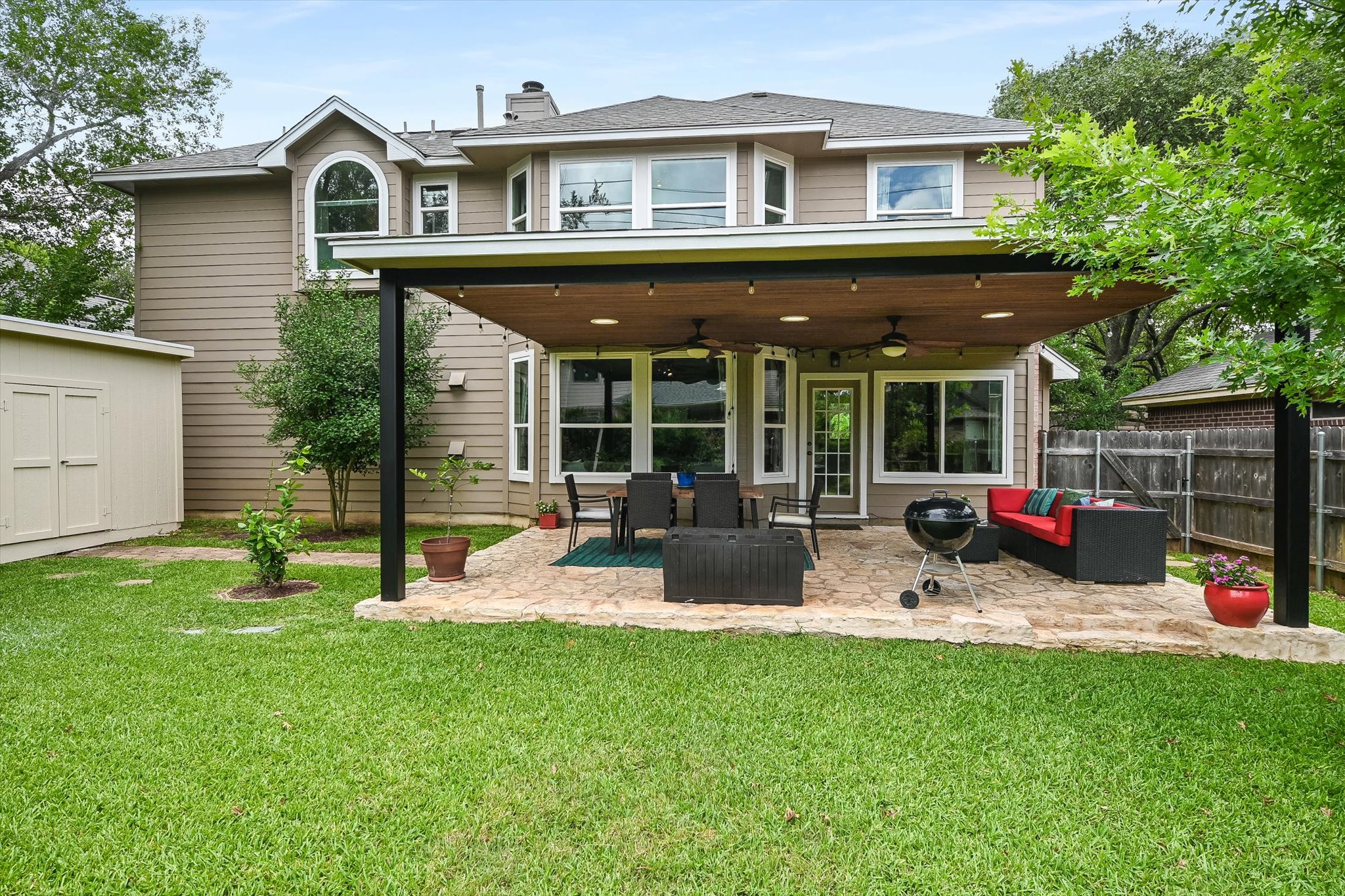 6456 Ruxton Lane Austin, TX 78749 - Photo 27 of 30 A private backyard oasis features a shaded patio, perfect for outdoor entertaining.
