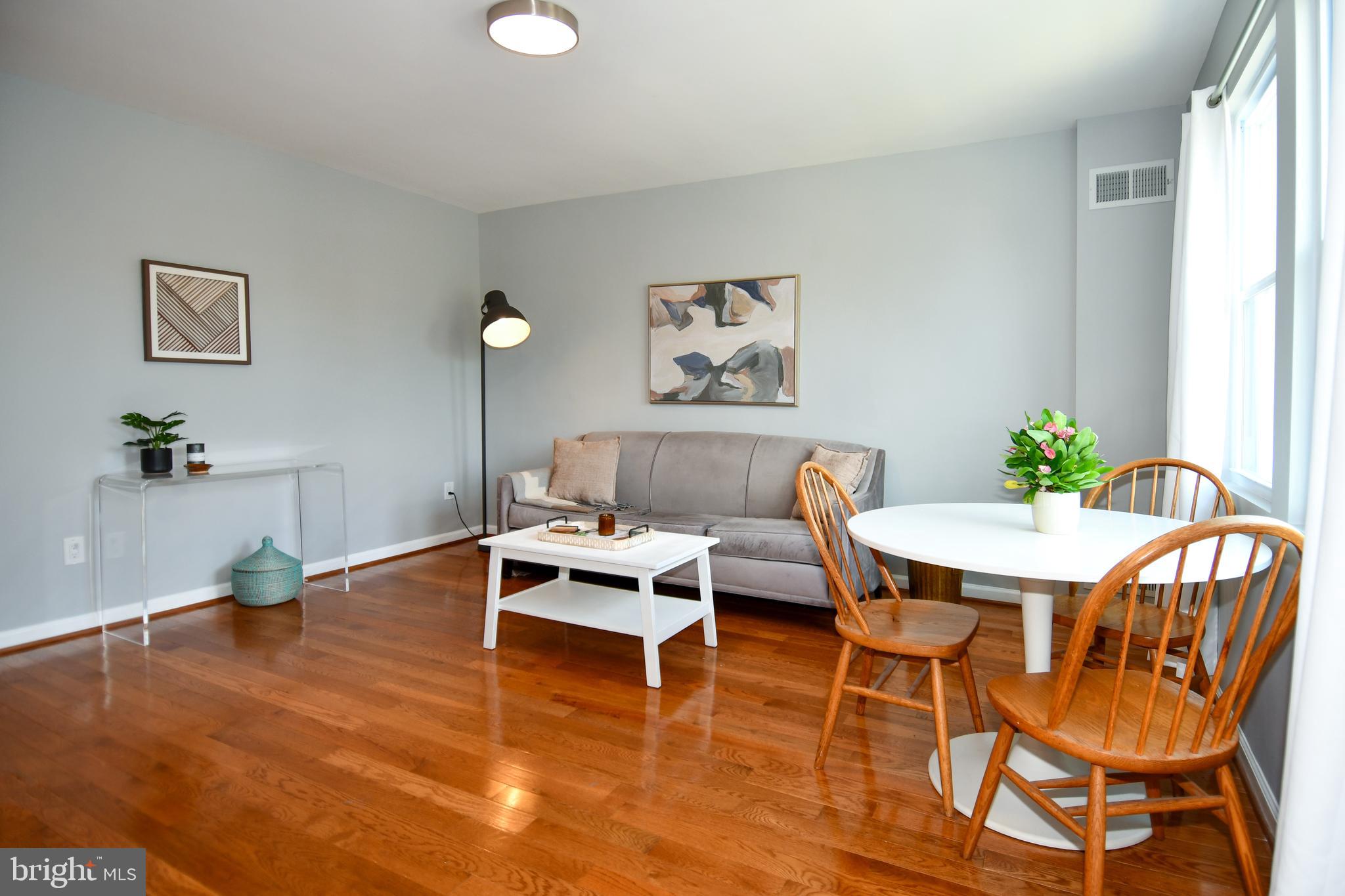 1643 Montello Avenue Northeast, Unit 4 Washington, DC 20002 - Photo 4 of 30 a living room with dining room and wooden floor