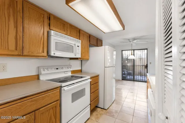 a view of a kitchen with electric appliances