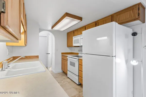 a view of a kitchen with electric appliances