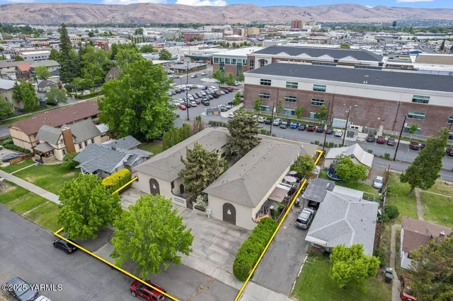 an aerial view of multiple houses with yard