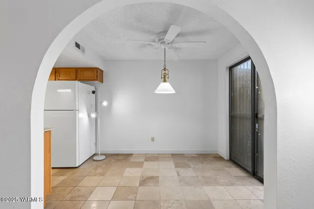 an empty room with a bathroom and a mirror