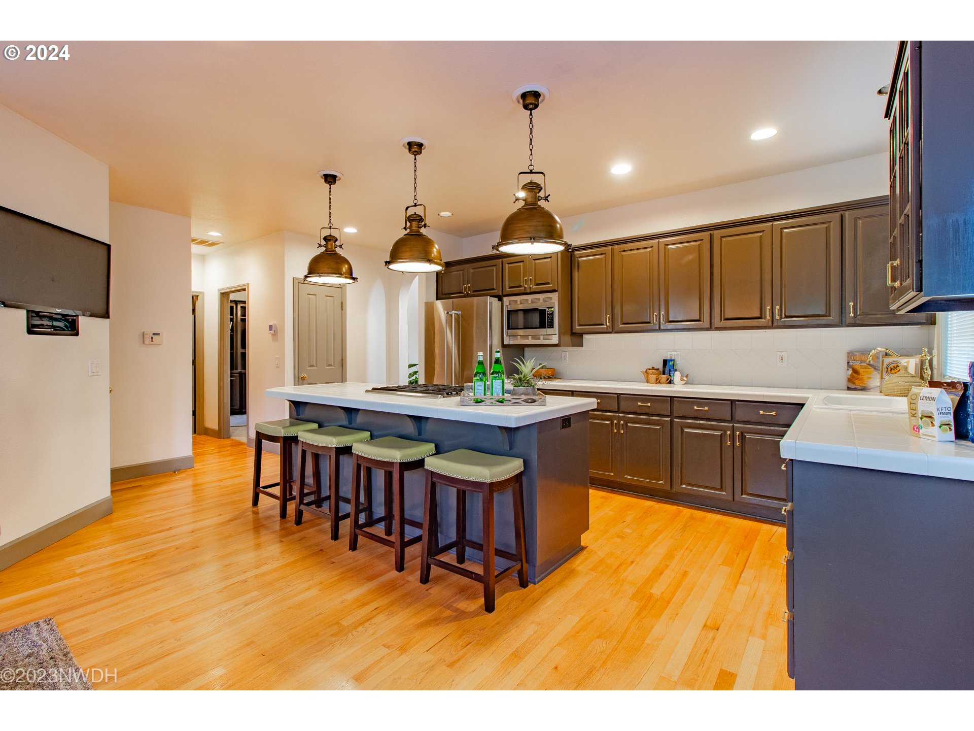 3435 Hampton Way Eugene, OR 97401 - Photo 17 of 46 a kitchen with stainless steel appliances granite countertop a sink a stove and a refrigerator