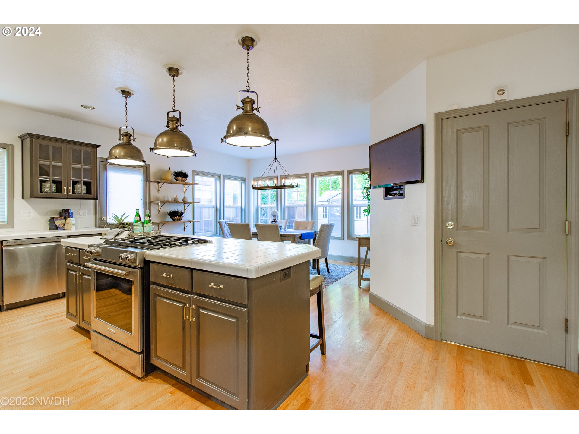 3435 Hampton Way Eugene, OR 97401 - Photo 18 of 46 a kitchen with stainless steel appliances granite countertop a sink a stove and a wooden floors