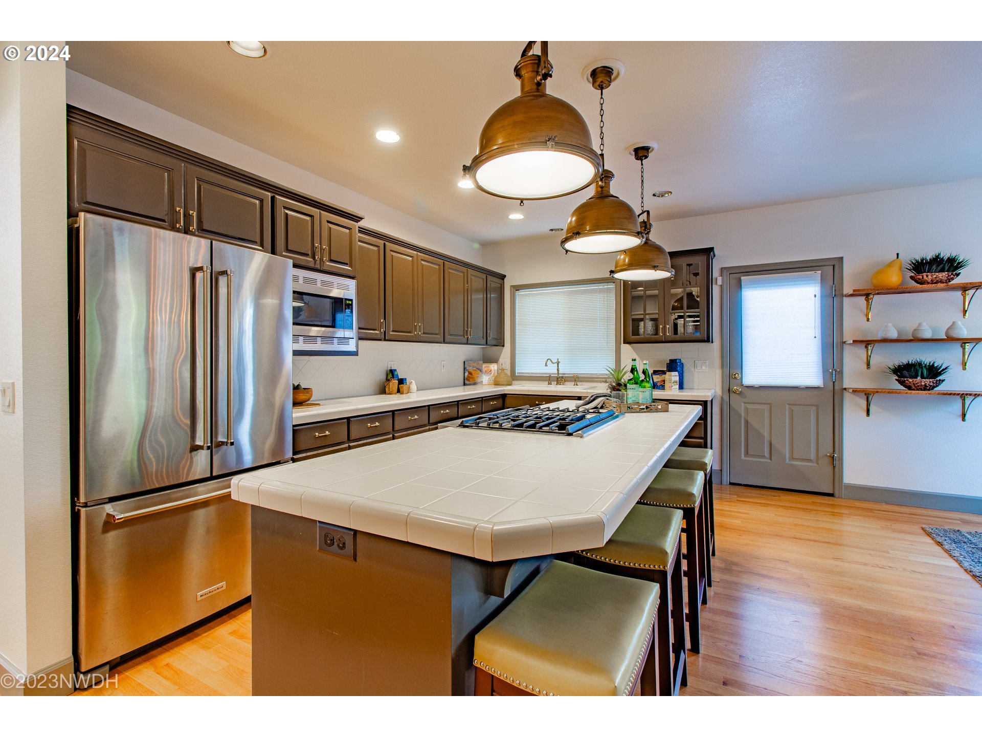 3435 Hampton Way Eugene, OR 97401 - Photo 19 of 46 a kitchen with stainless steel appliances a table chairs and refrigerator