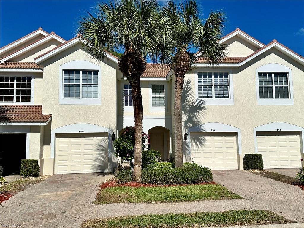 860 Hampton Circle, Unit 165 Naples, FL 34105 - Photo 1 of 38 a front view of a house with garden