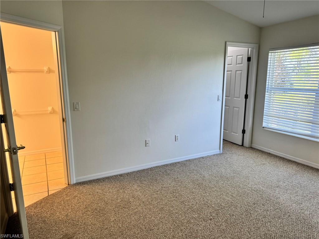 860 Hampton Circle, Unit 165 Naples, FL 34105 - Photo 11 of 38 a view of an empty room with a window