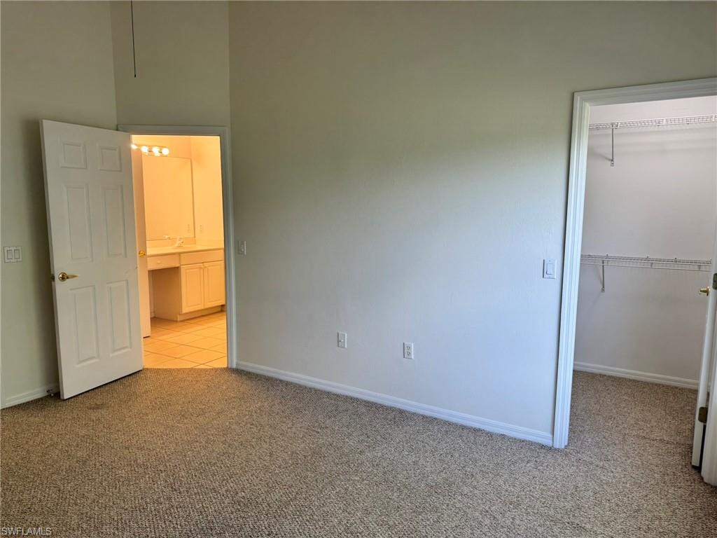 860 Hampton Circle, Unit 165 Naples, FL 34105 - Photo 12 of 38 a view of an empty room with a window
