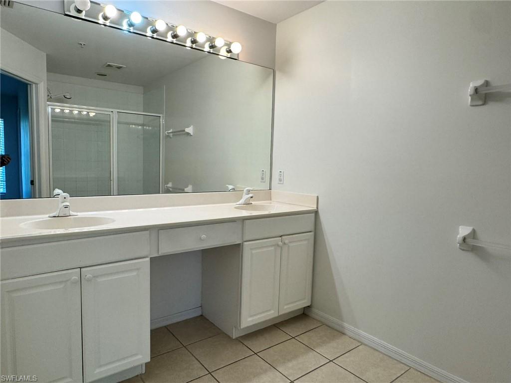 860 Hampton Circle, Unit 165 Naples, FL 34105 - Photo 14 of 38 a bathroom with a double vanity sink mirror and