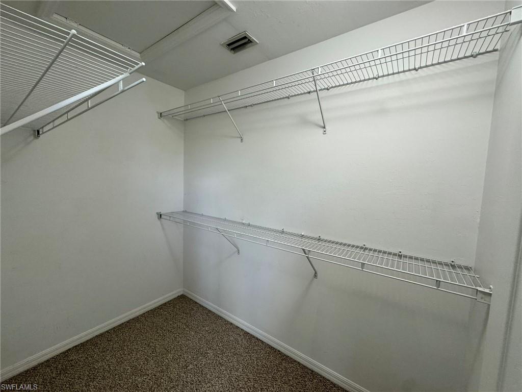 860 Hampton Circle, Unit 165 Naples, FL 34105 - Photo 17 of 38 a view of a room with racks on the wall