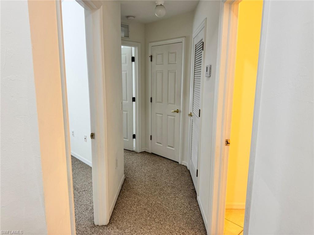 860 Hampton Circle, Unit 165 Naples, FL 34105 - Photo 18 of 38 a view of a bathroom with a tub and shower curtain