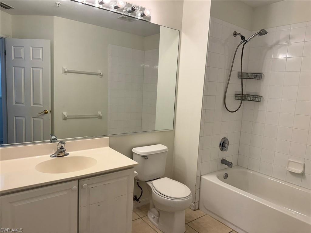 860 Hampton Circle, Unit 165 Naples, FL 34105 - Photo 19 of 38 a bathroom with a sink a toilet and shower