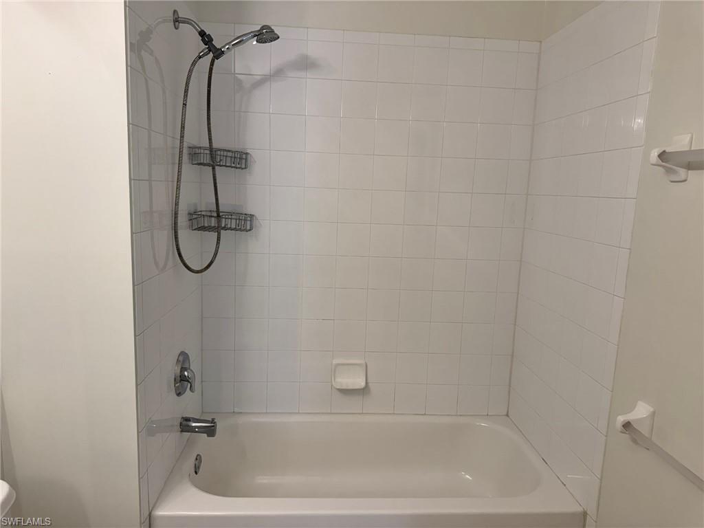860 Hampton Circle, Unit 165 Naples, FL 34105 - Photo 20 of 38 a bathroom with a bath tub and a shower