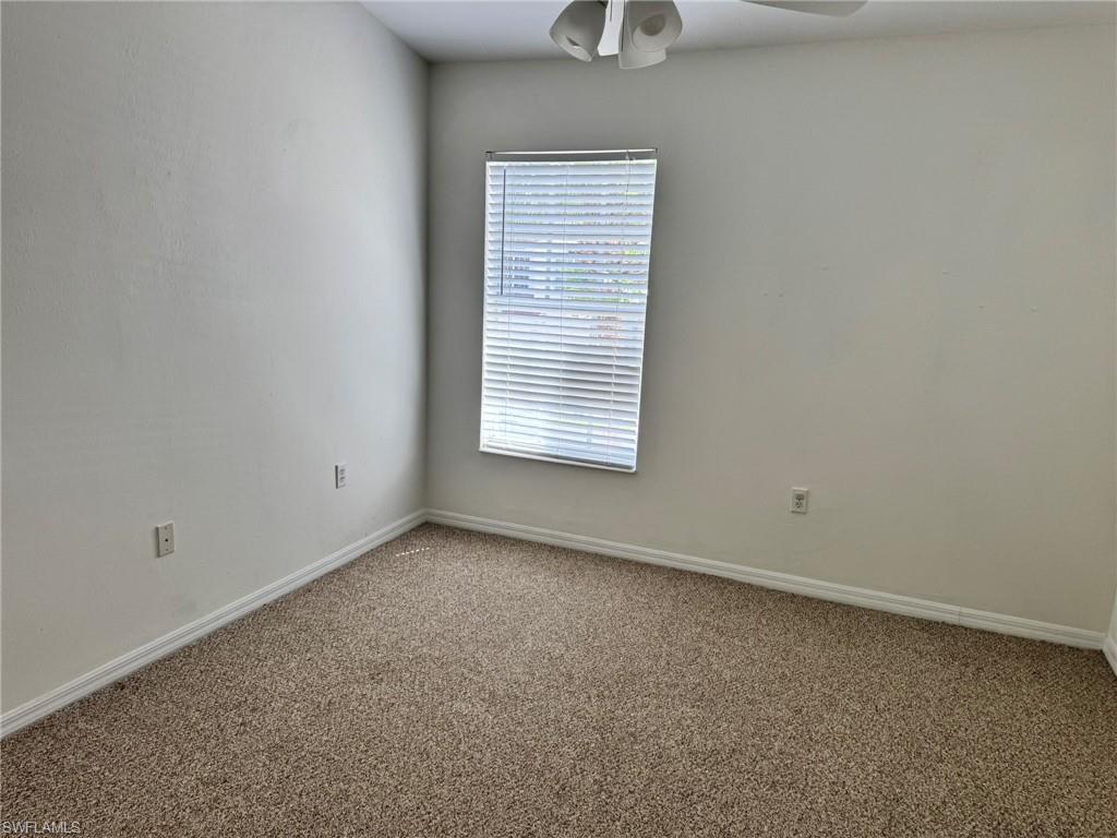 860 Hampton Circle, Unit 165 Naples, FL 34105 - Photo 21 of 38 an empty room with a window