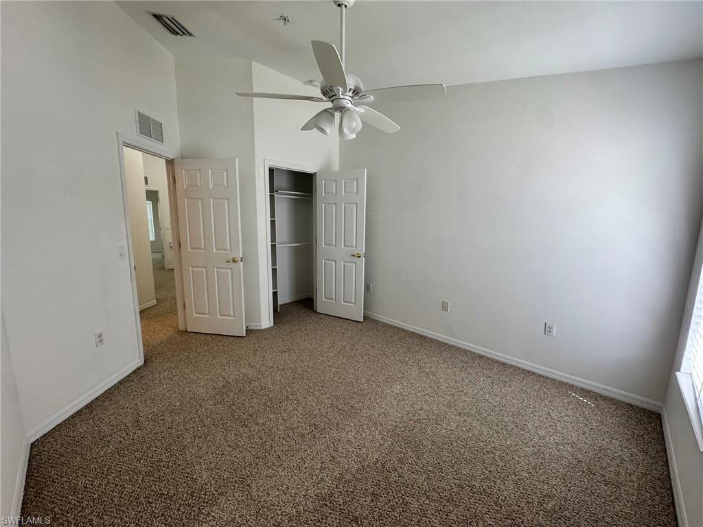 860 Hampton Circle, Unit 165 Naples, FL 34105 - Photo 23 of 38 an empty room with closet and ceiling fan