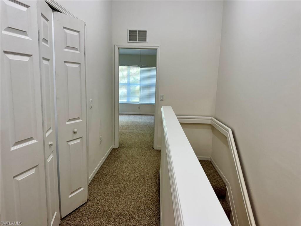 860 Hampton Circle, Unit 165 Naples, FL 34105 - Photo 29 of 38 wooden floor in a gallery