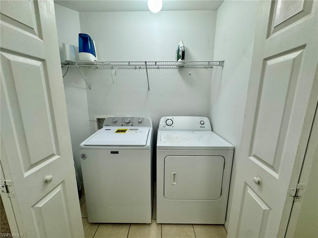 860 Hampton Circle, Unit 165 Naples, FL 34105 - Photo 30 of 38 a utility room with dryer and washer