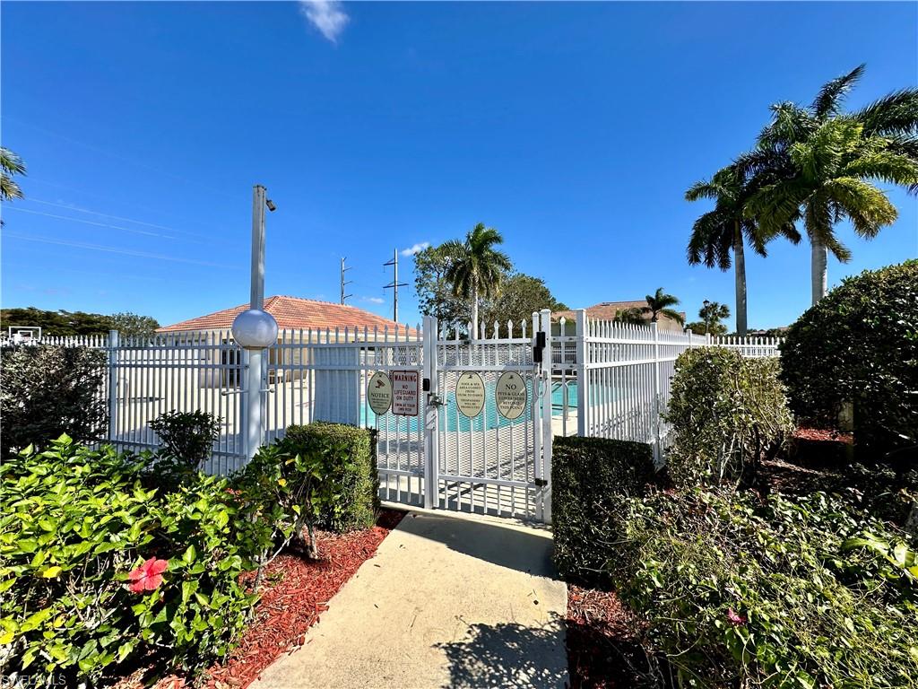 860 Hampton Circle, Unit 165 Naples, FL 34105 - Photo 34 of 38 a view of a house with a garden