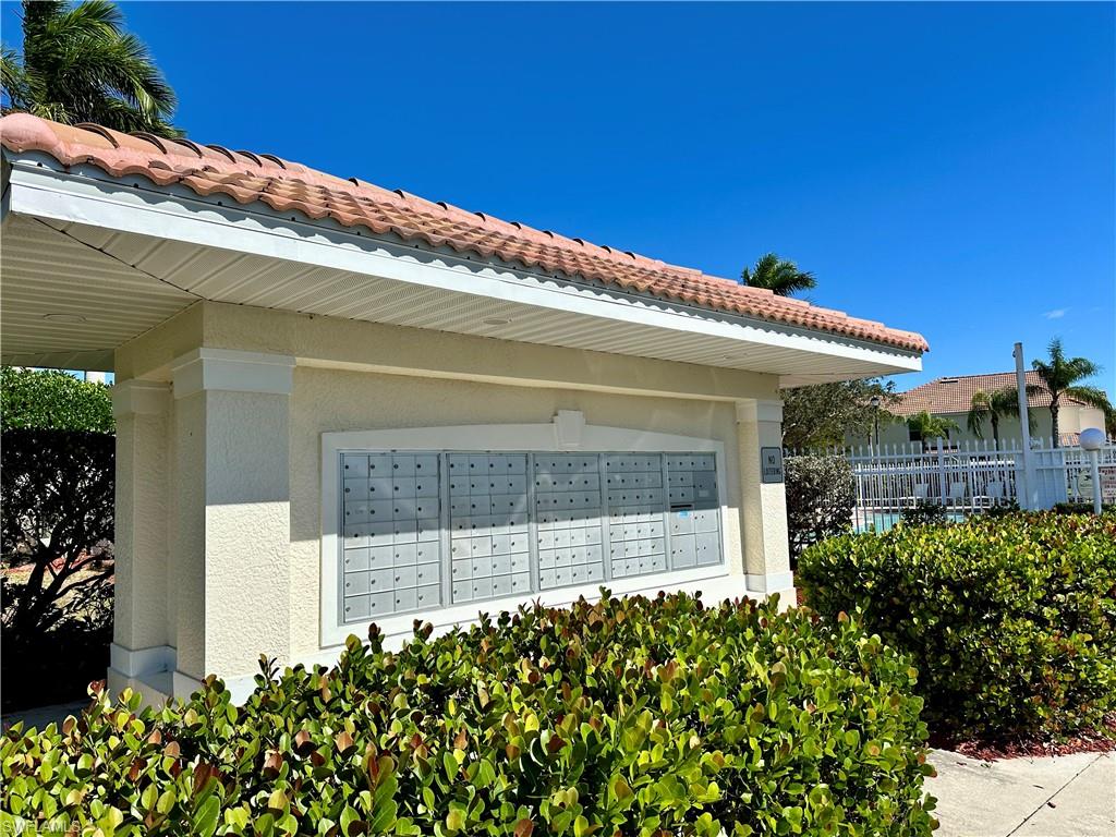 860 Hampton Circle, Unit 165 Naples, FL 34105 - Photo 35 of 38 a front view of a house with a garden