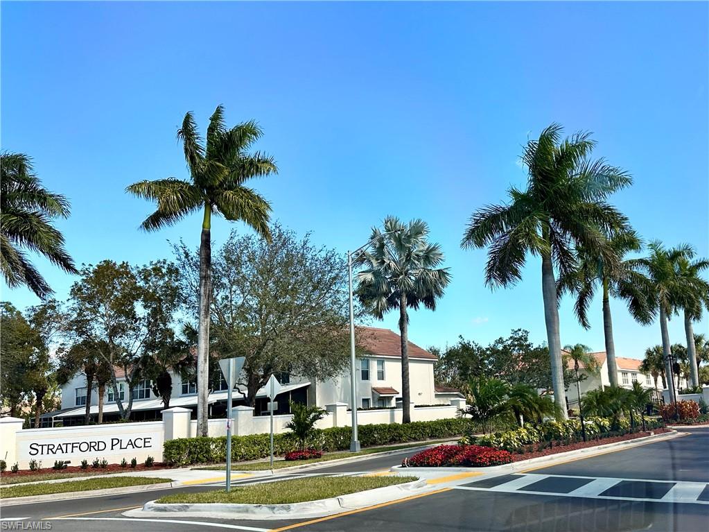 860 Hampton Circle, Unit 165 Naples, FL 34105 - Photo 38 of 38 a front view of multi story residential apartment building with yard and sign board