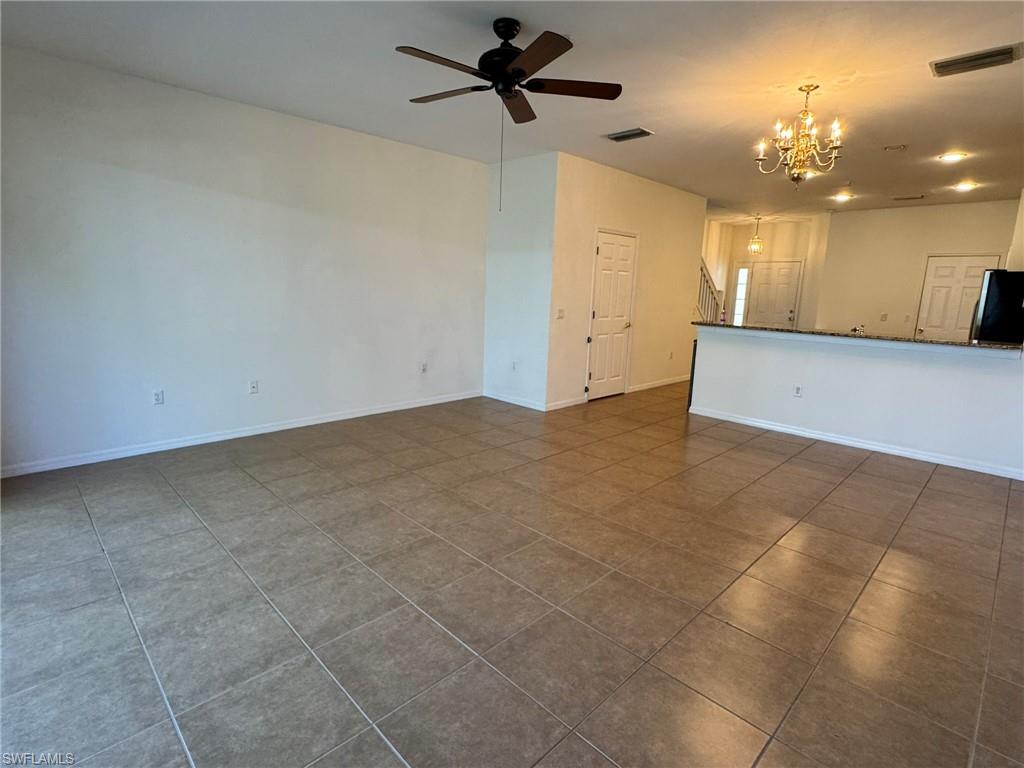 860 Hampton Circle, Unit 165 Naples, FL 34105 - Photo 6 of 38 an empty room with a ceiling fan and a window