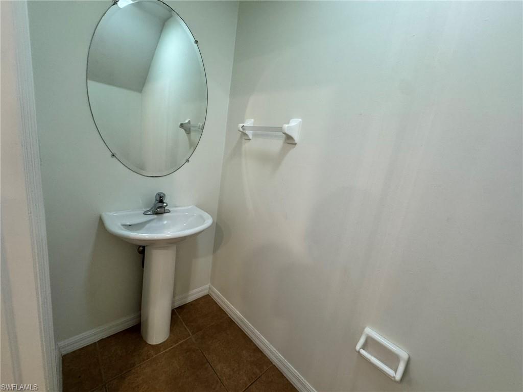 860 Hampton Circle, Unit 165 Naples, FL 34105 - Photo 8 of 38 a bathroom with a sink and mirror