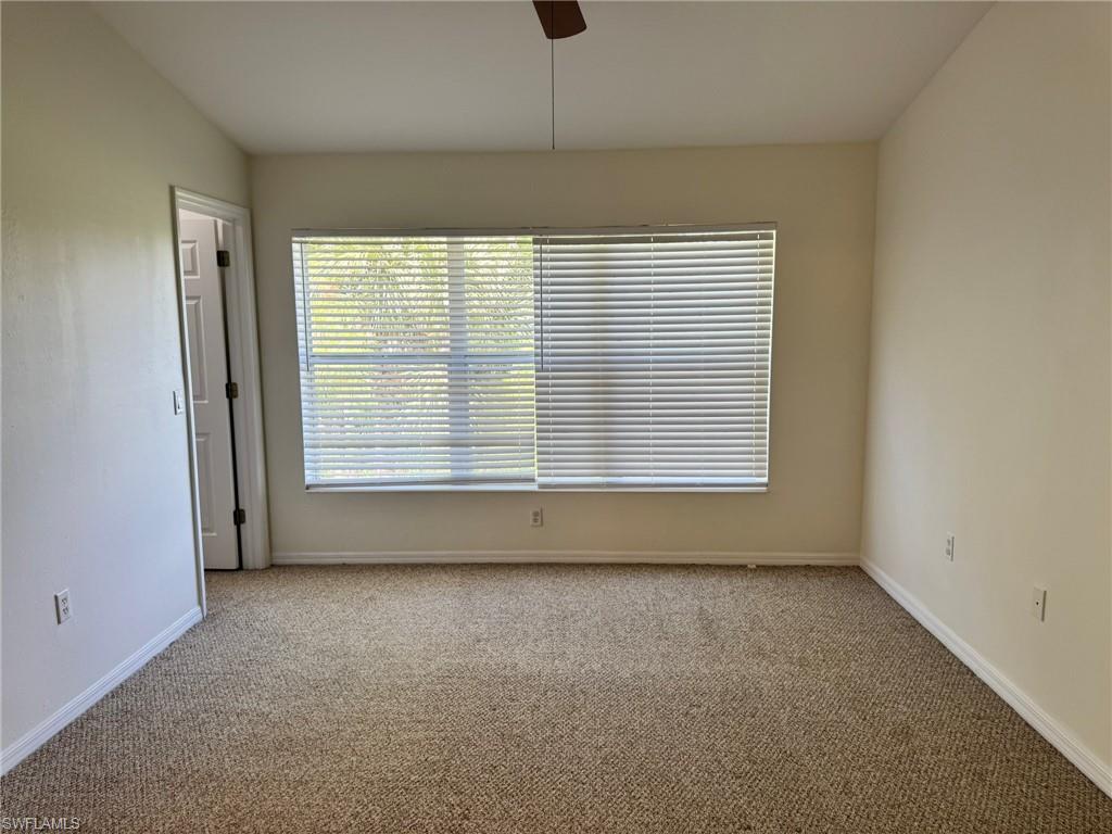 860 Hampton Circle, Unit 165 Naples, FL 34105 - Photo 10 of 38 an empty room with a window