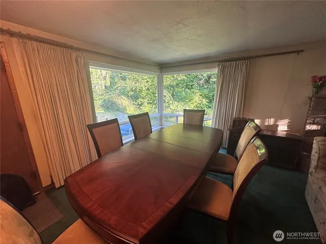 a view of a dining room with furniture window and outside view