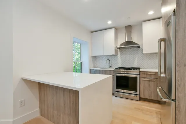 a kitchen with stainless steel appliances a sink and a stove
