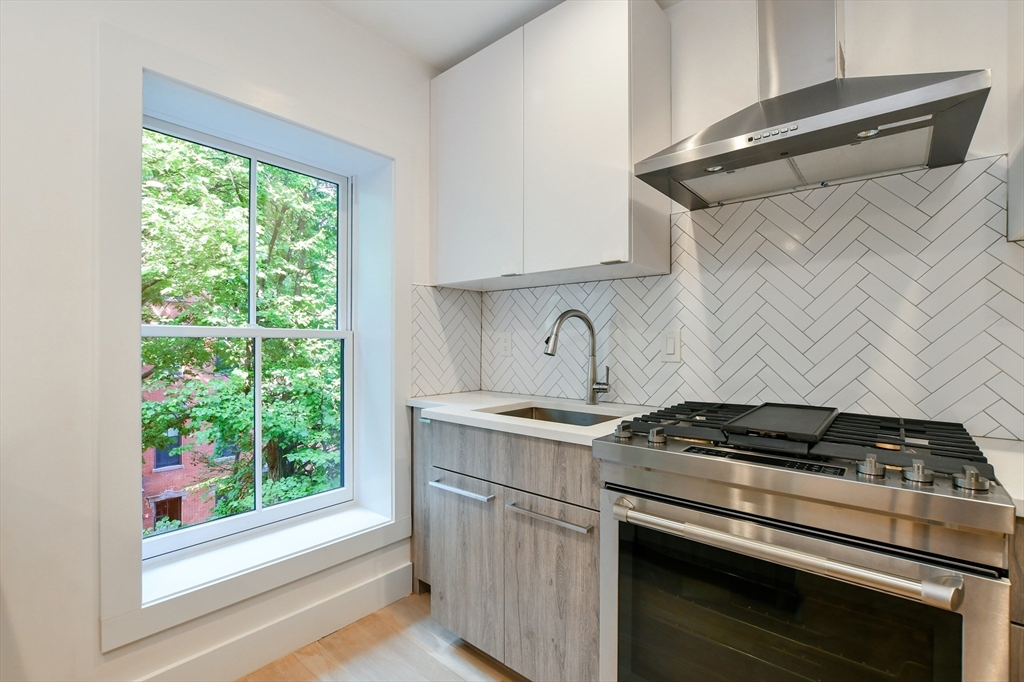 55 East Springfield Street, Unit 4 Boston, MA 02118 - Photo 7 of 16 a kitchen with a stove and a white cabinet