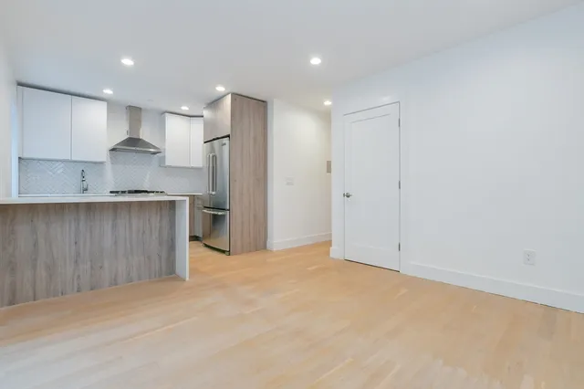 a view of kitchen with refrigerator and window