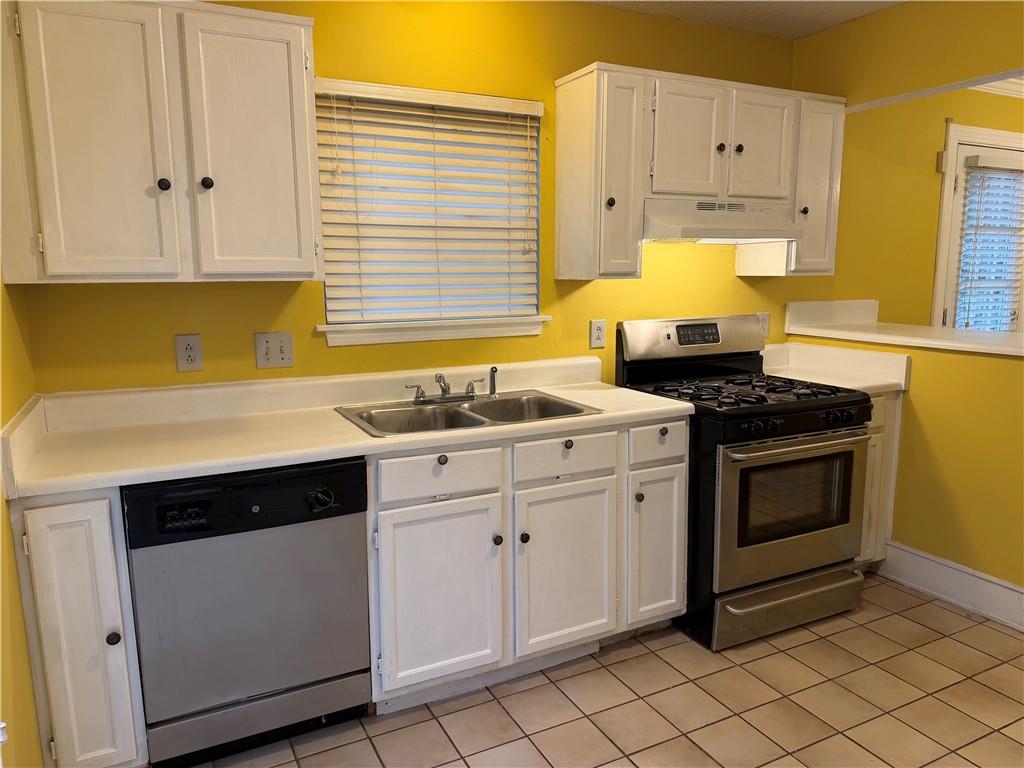 4608 Warners Trail Norcross, GA 30093 - Photo 12 of 23 a kitchen with granite countertop white cabinets and white appliances